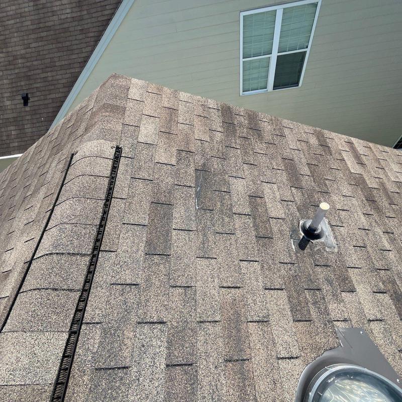 Asphalt shingle roof with vent pipe and ridge vent