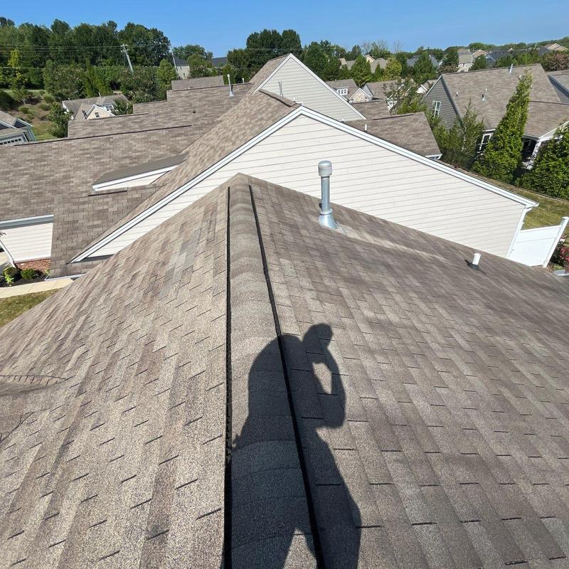 Asphalt shingle roof with vent pipes and shadow