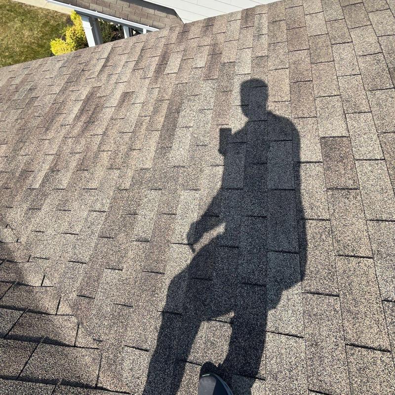 Asphalt shingle roof with hail damage inspection shadow