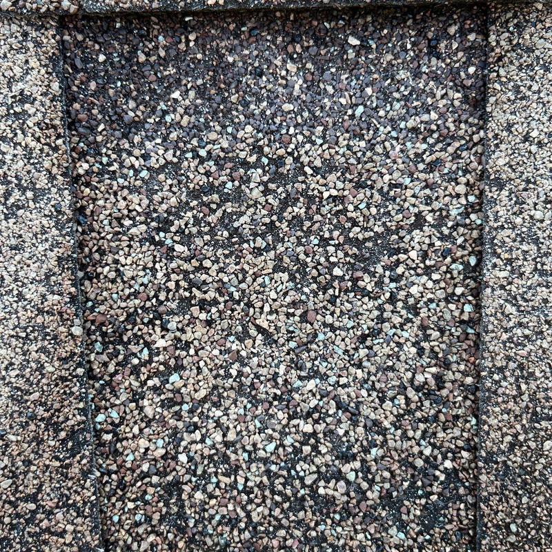 Roof shingles with hail damage and granule loss