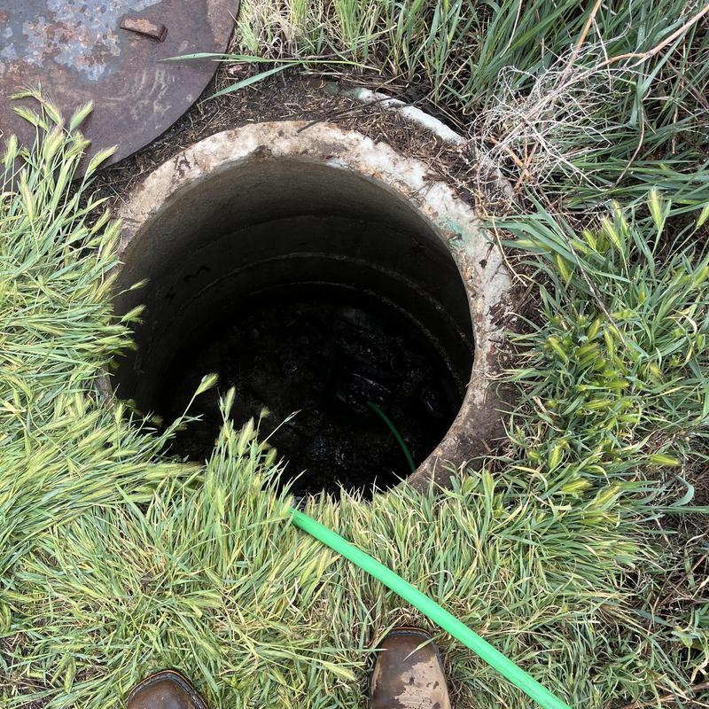 Storm drain opening with hose for hydro jetting cleaning