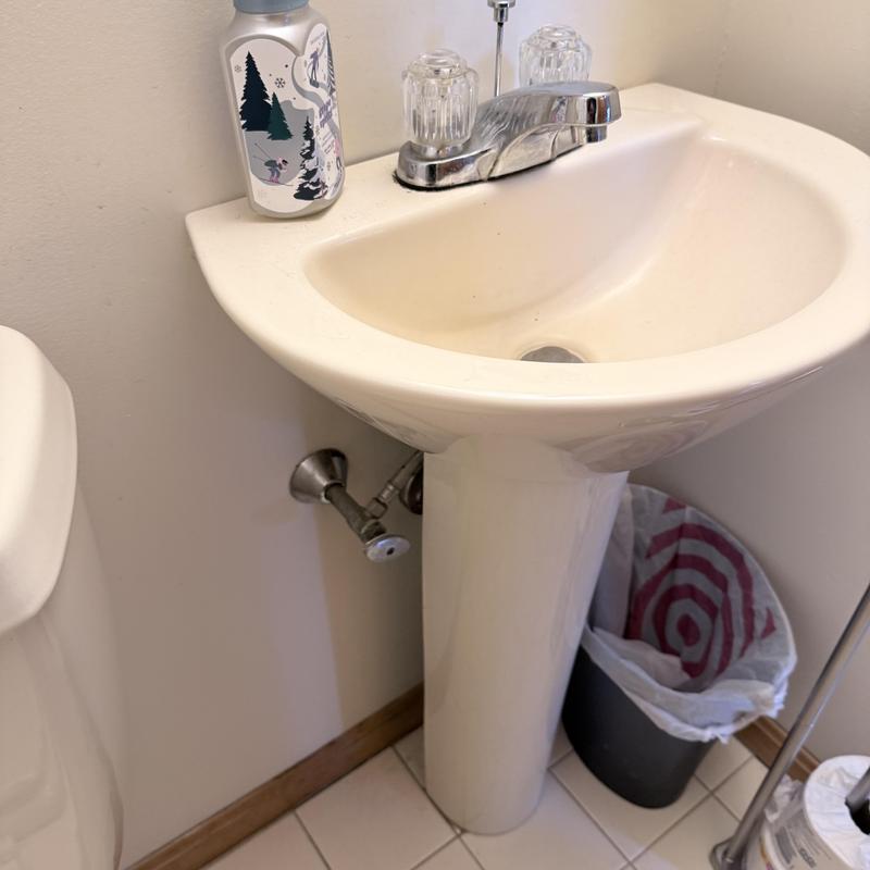 Bathroom pedestal sink with faucet and soap dispenser