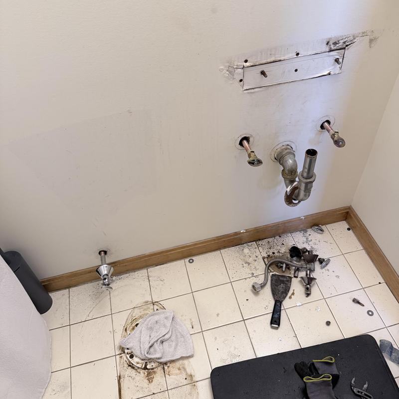 Bathroom vanity plumbing and drain with removed fixtures