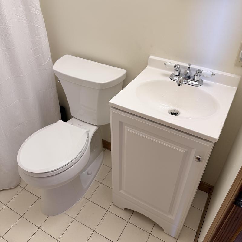 Toilet and vanity unit in bathroom corner