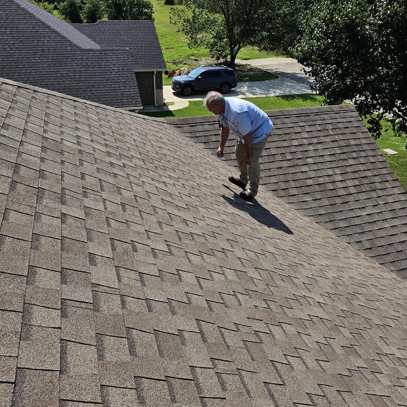 Asphalt shingle roof with hail damage inspection