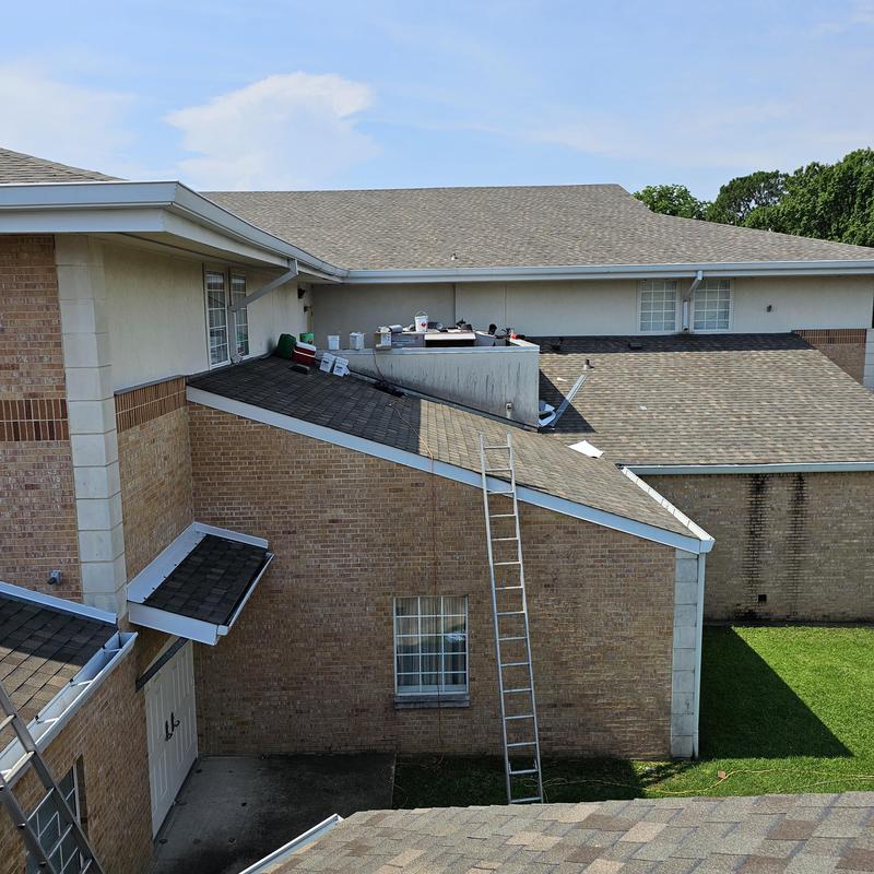 Asphalt shingle roof with ladder for hail damage repairs