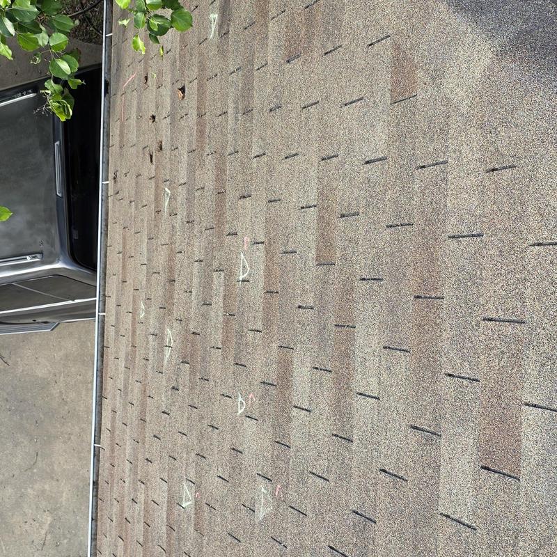 Asphalt roof shingles with hail damage markings