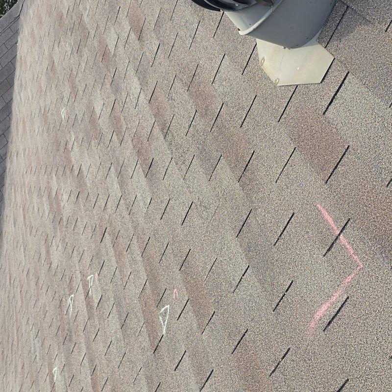 Asphalt shingles with hail damage and inspection markings