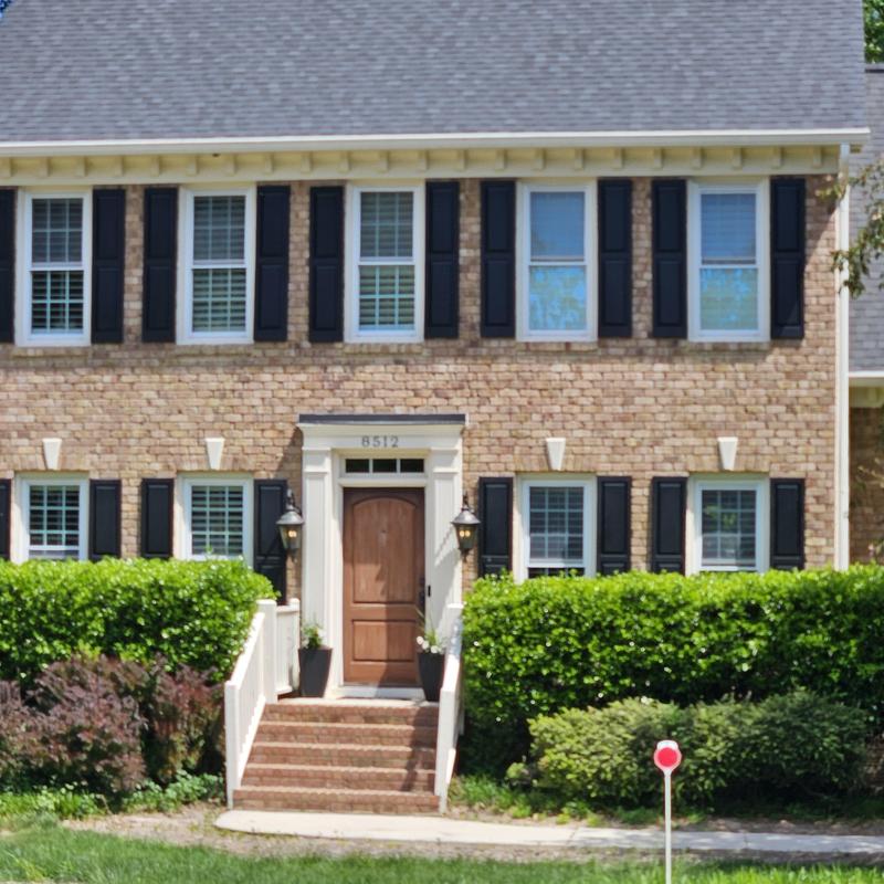 Brick exterior and front door with shutters Wake Forest home