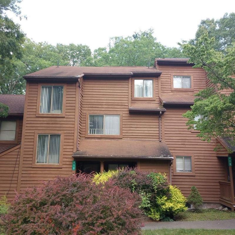 Townhouse roof with brown shingles and siding Townhouse roof with brown shingles and siding