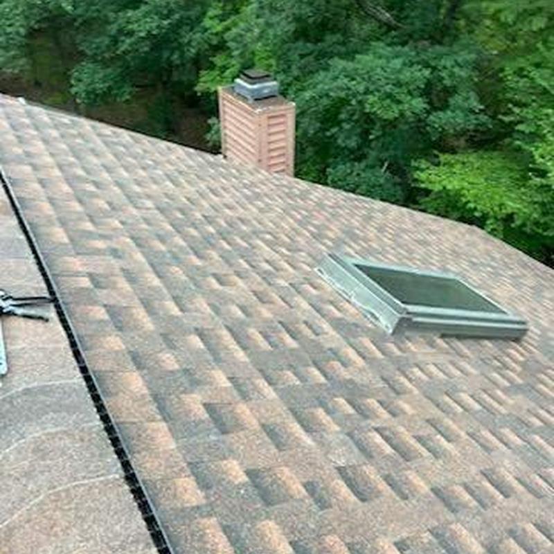 Asphalt shingle roof with skylight installation Asphalt shingle roof with skylight installation