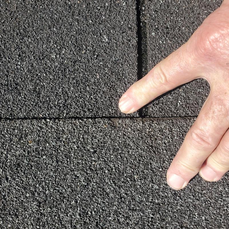 Asphalt roof shingles with hail damage close-up