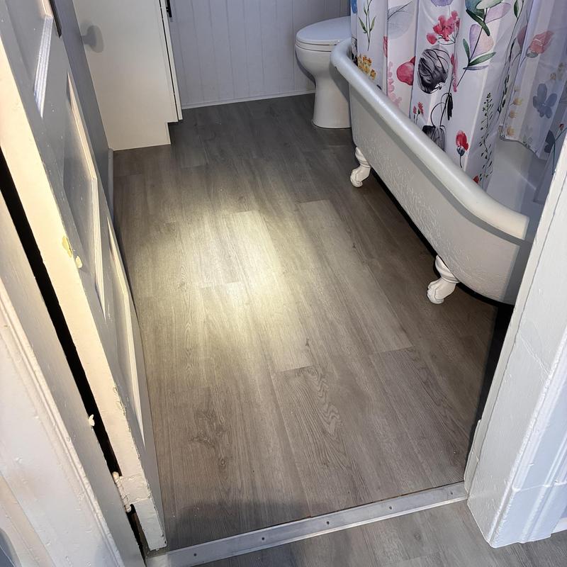 Vinyl bathroom flooring installation with toilet and tub Vinyl bathroom flooring installation with toilet and tub