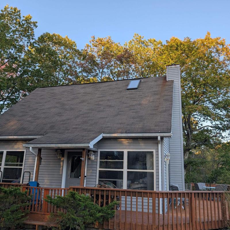 Asphalt shingle roof on residential home with deck Asphalt shingle roof on residential home with deck