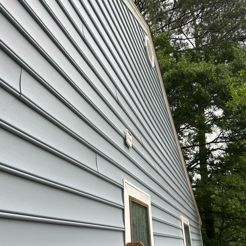 Vinyl siding installation on residential home exterior Vinyl siding installation on residential home exterior