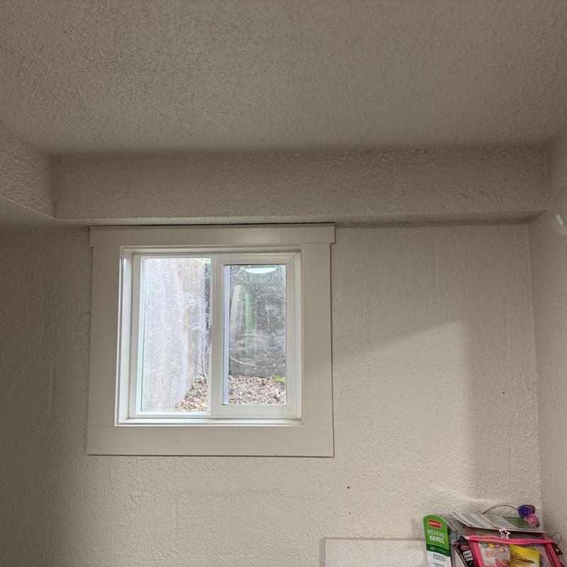 Window frame and wall texture in basement room