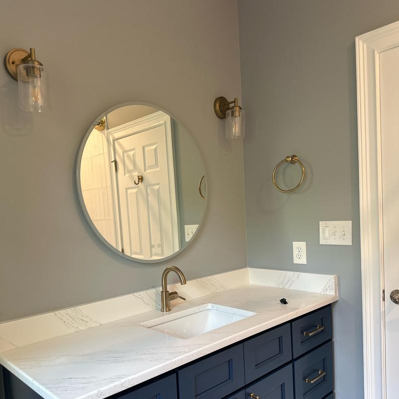 Bathroom vanity with marble countertop and brass fixtures Bathroom vanity with marble countertop and brass fixtures