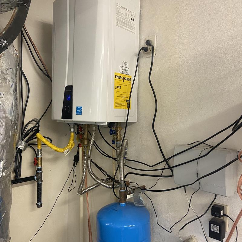 Tankless water heater with brass condensation line replacement