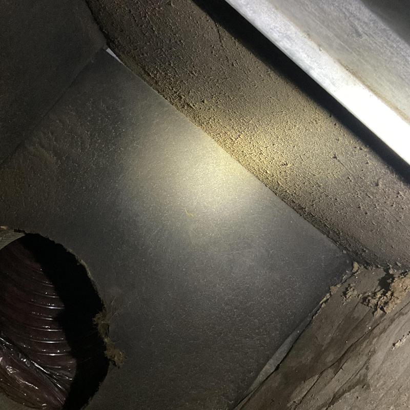 HVAC duct interior with dust buildup and debris