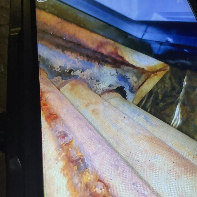 Rusty HVAC heat exchanger with corrosion damage