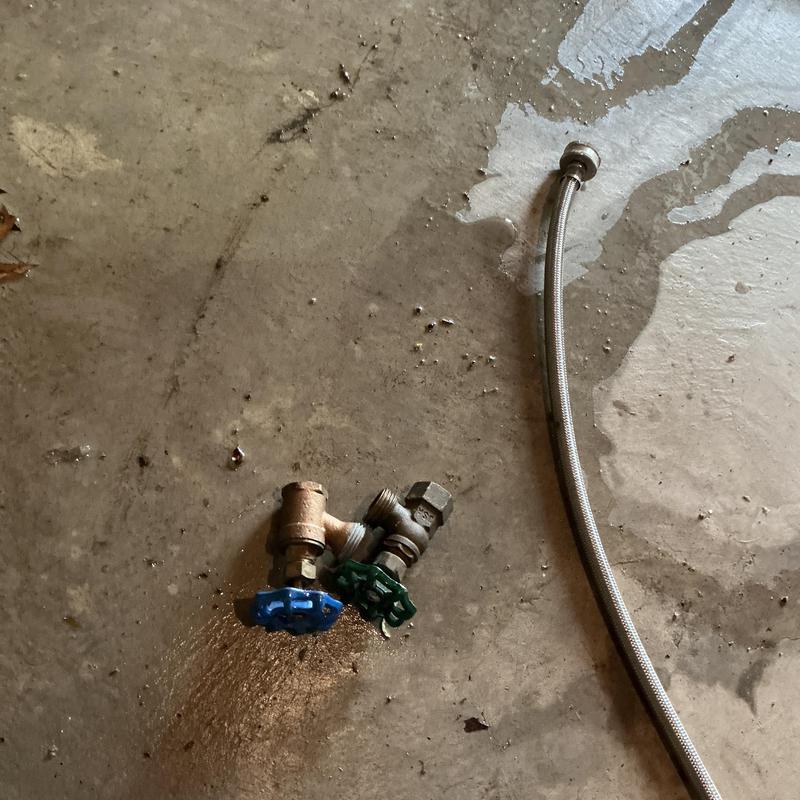 Washer emergency shut-off valves and hose on floor