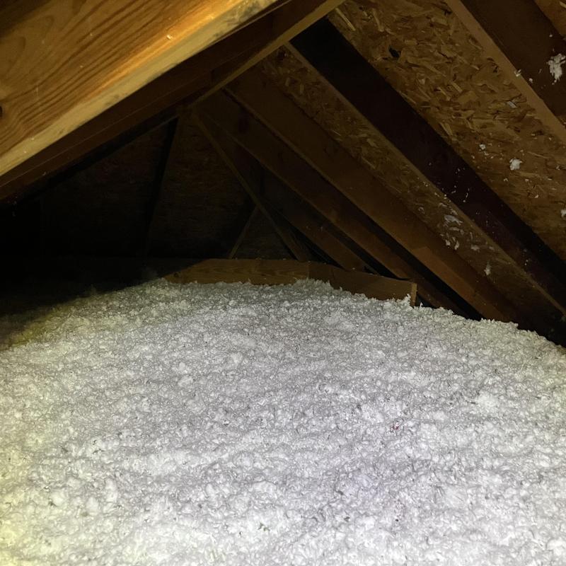 Attic cellulose insulation installed beneath roof rafters