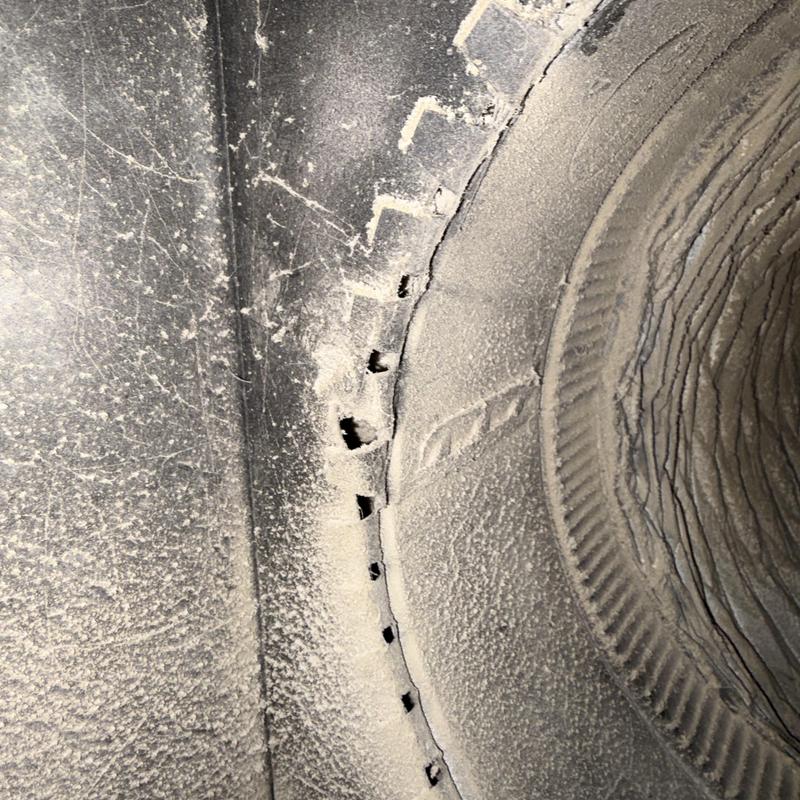 Ductwork with multiple rodent damage holes visible