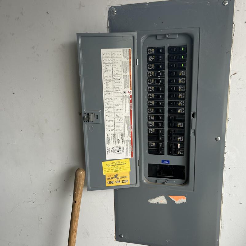 Electrical breaker panel with open door in residential setting