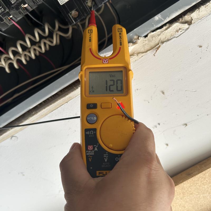 Circuit voltage testing with clamp meter in electrical panel