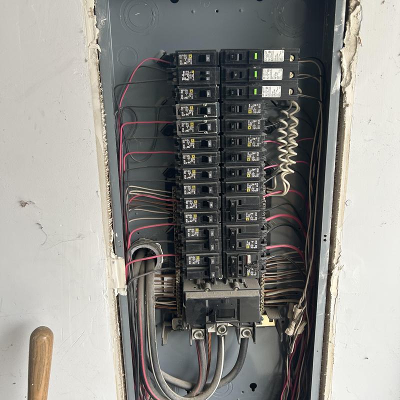 Electrical breaker panel with circuit wiring exposed