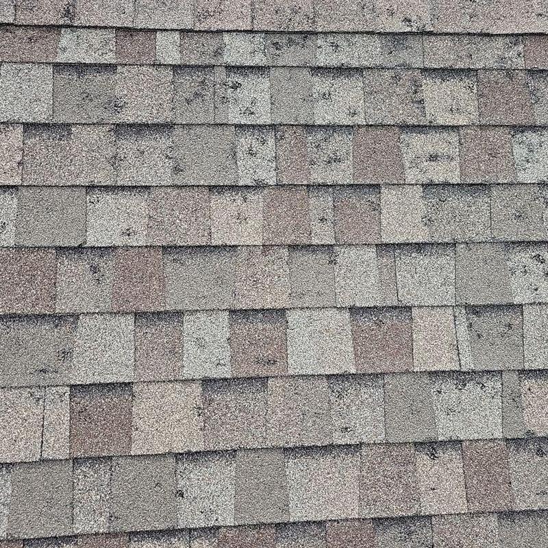 Shingle roof with hail damage and spots