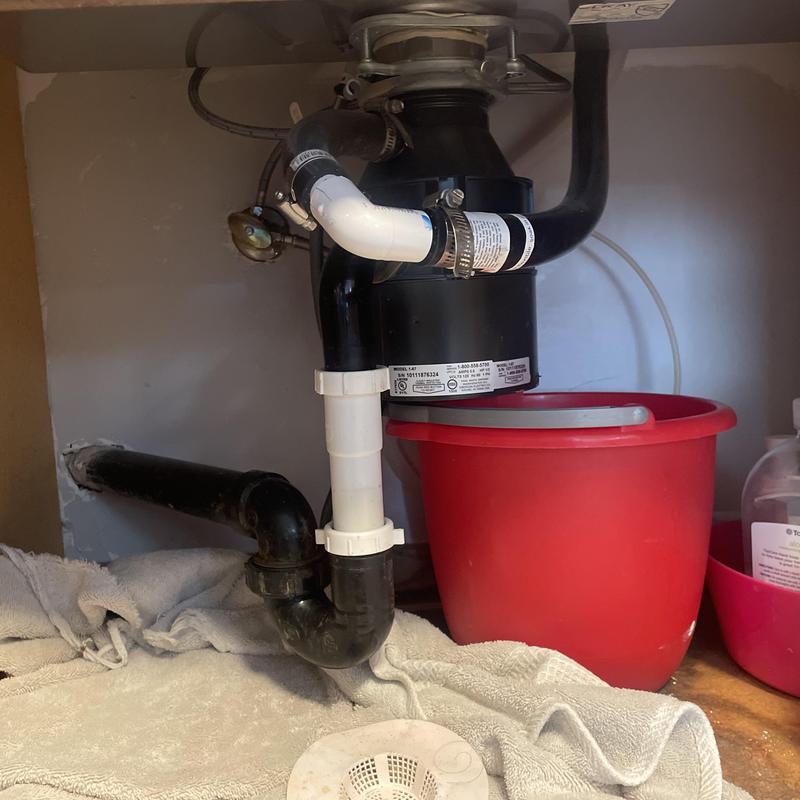 Garbage disposal and drain pipe under kitchen sink