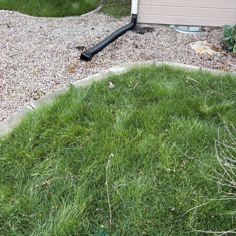 French drain outdoor drainage inspection near house wall