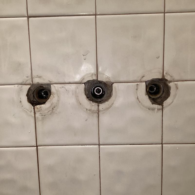 Three-handle shower valve with exposed plumbing parts