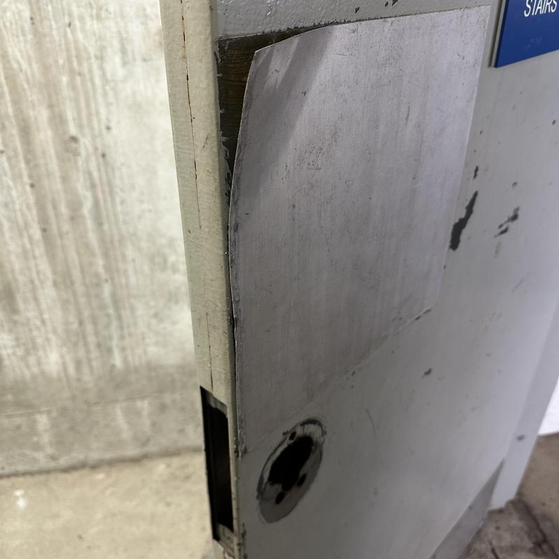 Parking garage door with removed lock and door wrap