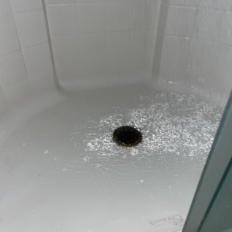 Shower drain clearing with flowing water in stall