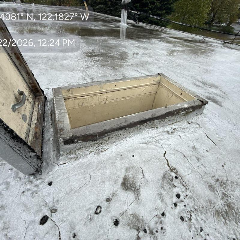 Roof hatch opening on flat roof with sealant
