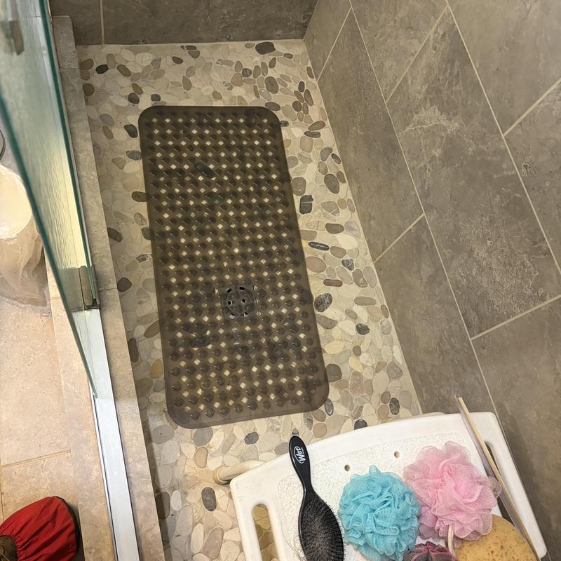 Shower floor with pebble tile and drain mat