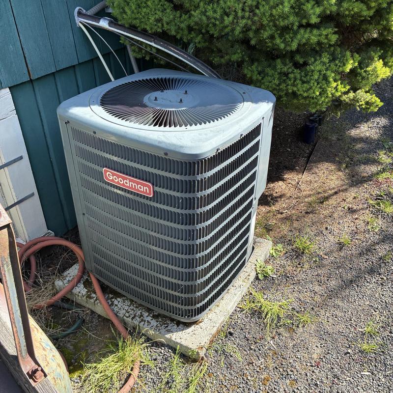 Goodman outdoor AC condenser unit on concrete pad Goodman outdoor AC condenser unit on concrete pad