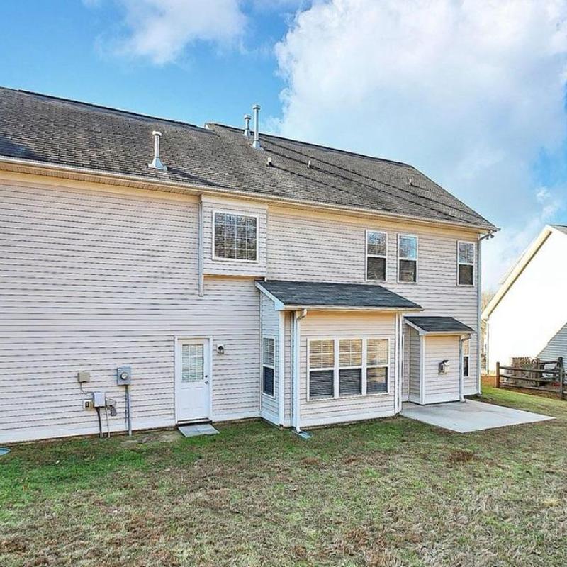 Roof with aging shingles on two-story house