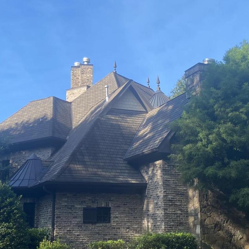 Designer shingle roofing on a multi-peak brick house