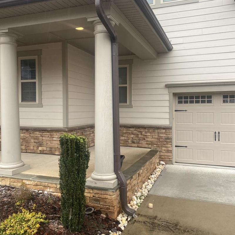 Gutter downspout and fascia board near porch columns