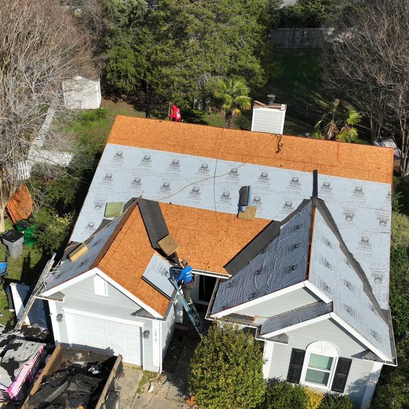 Roof decking installation with moisture barrier on house