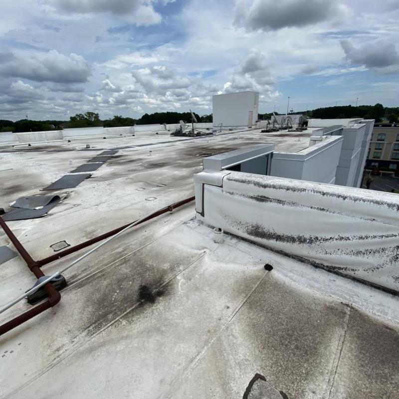 .60 TPO commercial roof with visible wear and debris