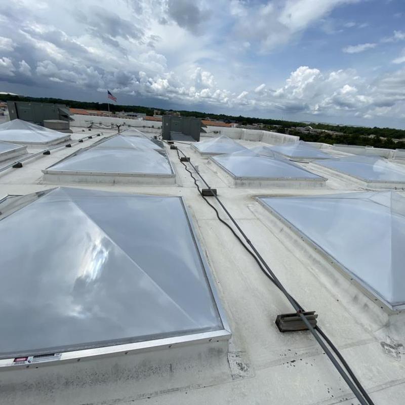Commercial TPO roof with multiple skylights and vents
