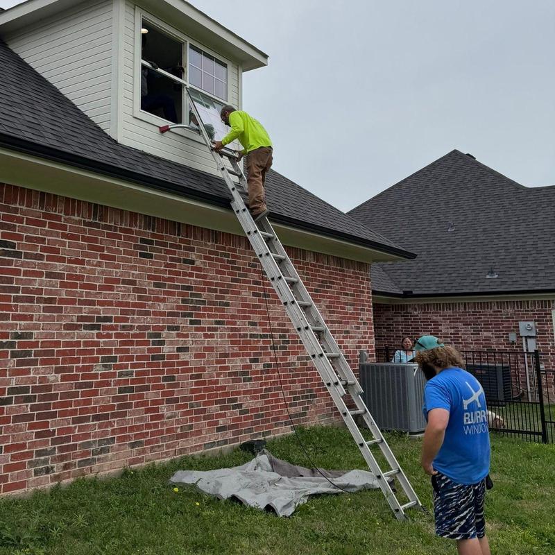 Vinyl window installation on second-story brick home