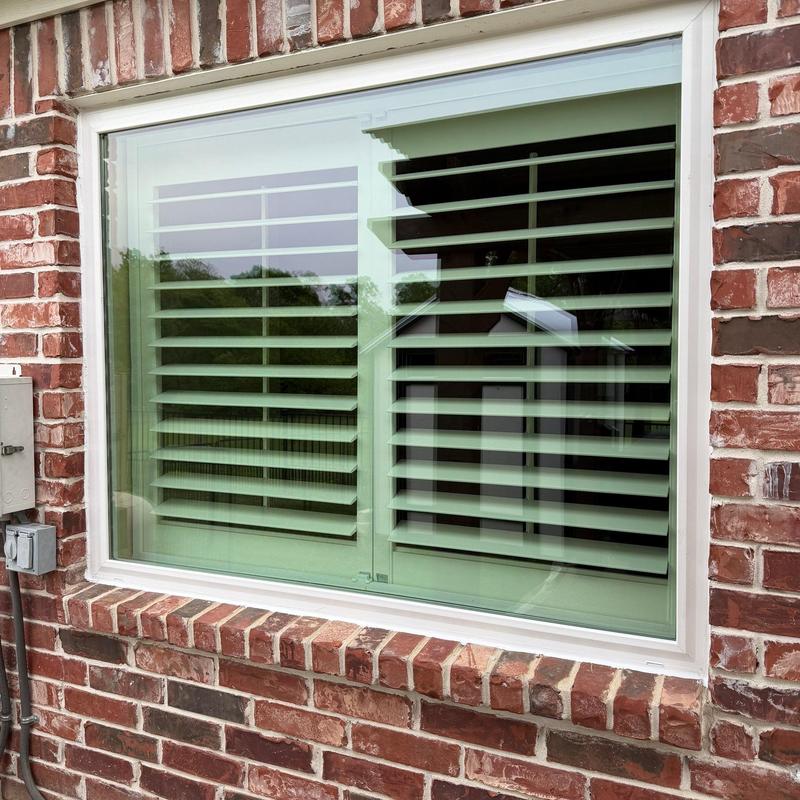 Vinyl energy-efficient window in brick wall