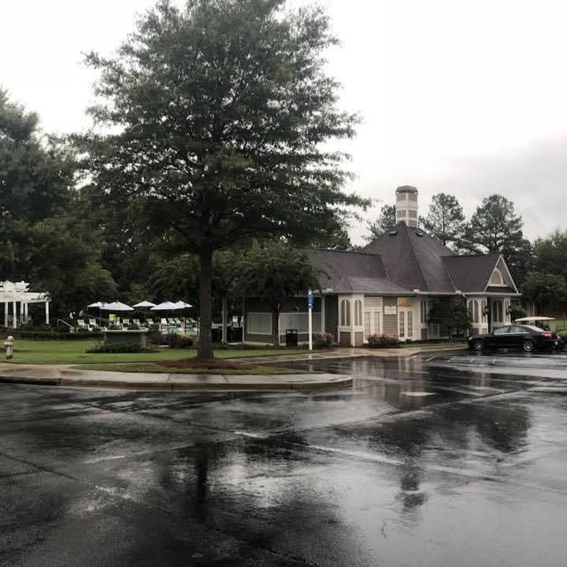 Pool house roof with new shingles on wet day