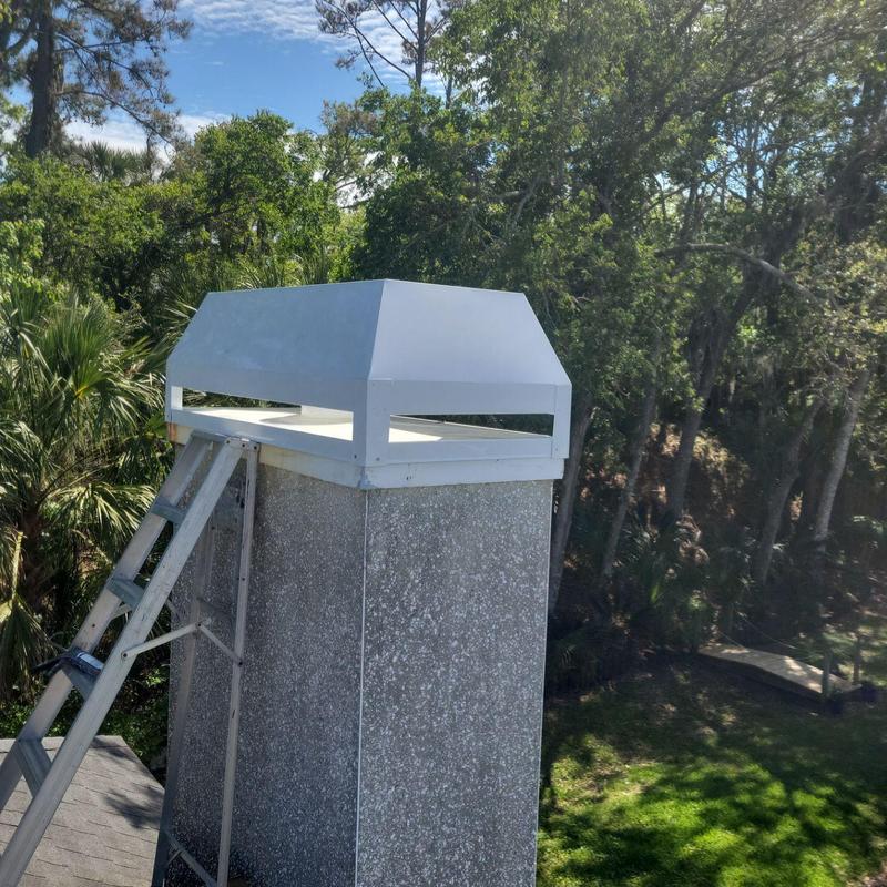 Chimney cap replacement with ladder on shingled roof