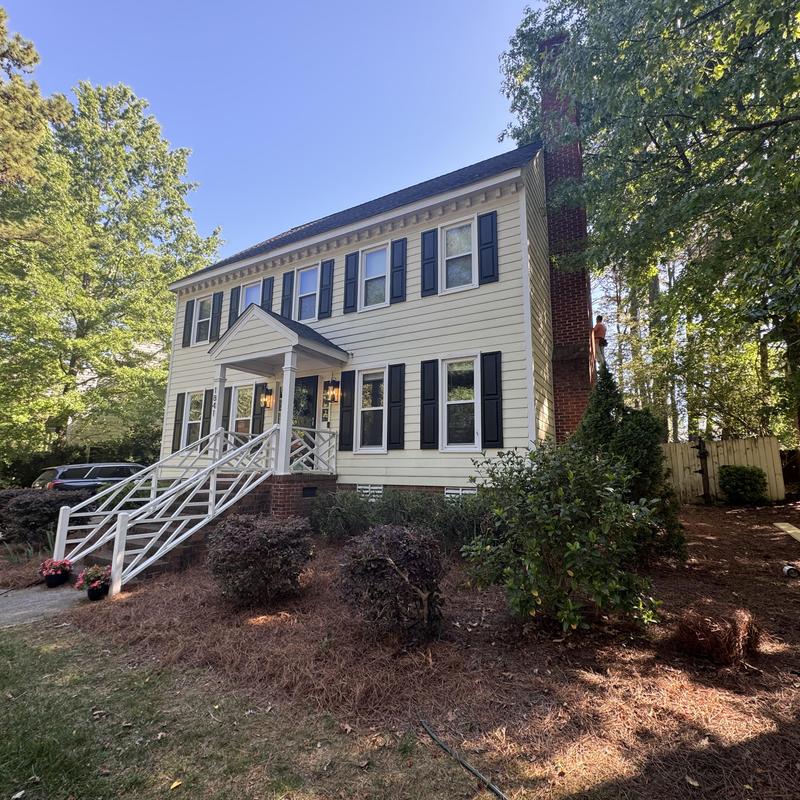 Siding on two-story home with black shutters Siding on two-story home with black shutters